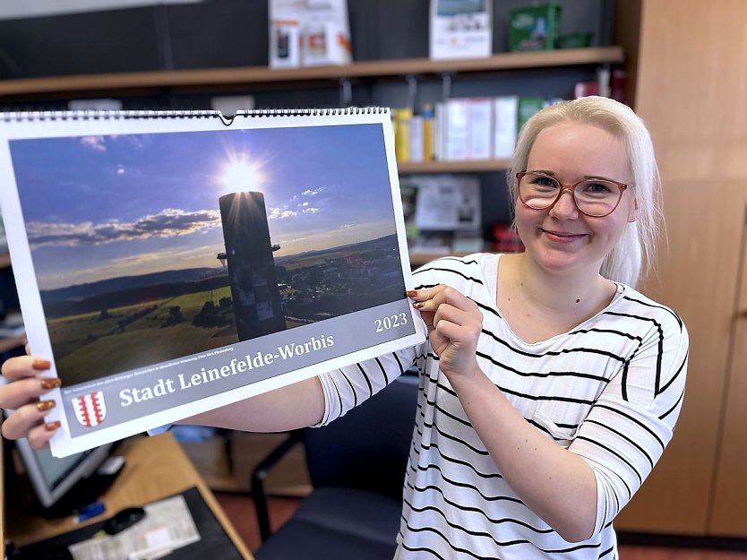 Stadtmitarbeiterin Michelle Enge mit dem neuen Jahreskalender 2023, der ab sofort in den B&uuml;rgerb&uuml;ros erh&auml;ltlich ist.  (Foto: Ren&eacute; Wei&szlig;bach)
